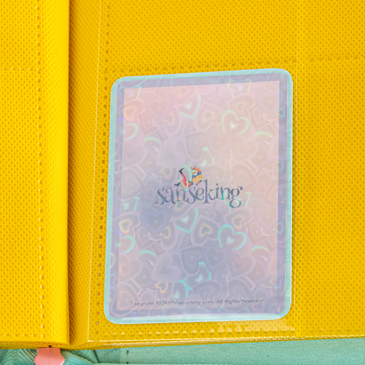 Love Heart-Shape Laser Flashing Rounded Card Sleeves – Green card sleeve stored in a binder page