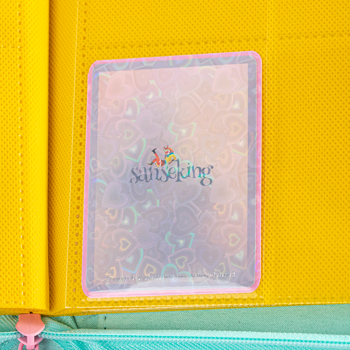 Love Heart-Shape Laser Flashing Rounded Card Sleeves – Pink card sleeve stored in a binder page