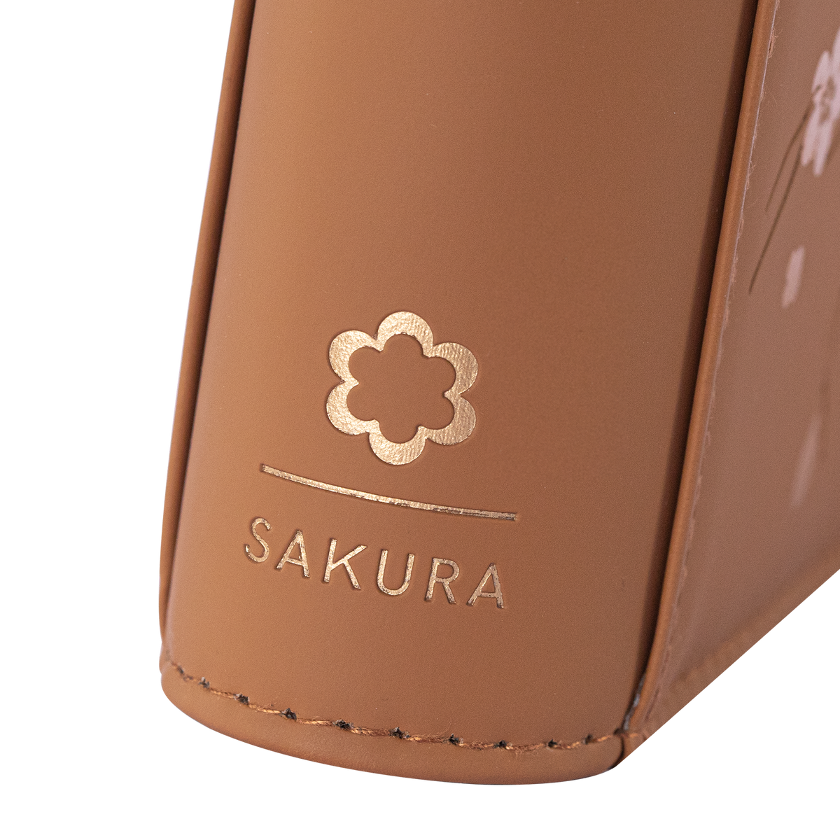 Angled view of the SAKURA emblem on the Brown card binder