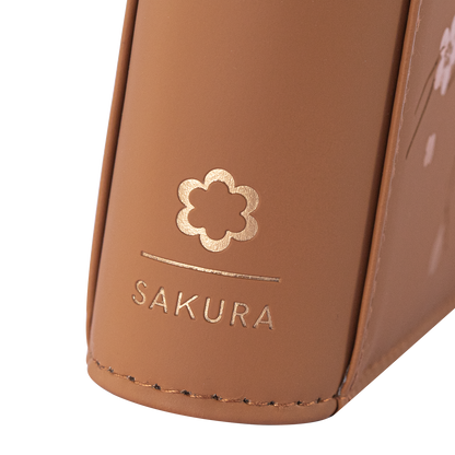 Angled view of the SAKURA emblem on the Brown card binder