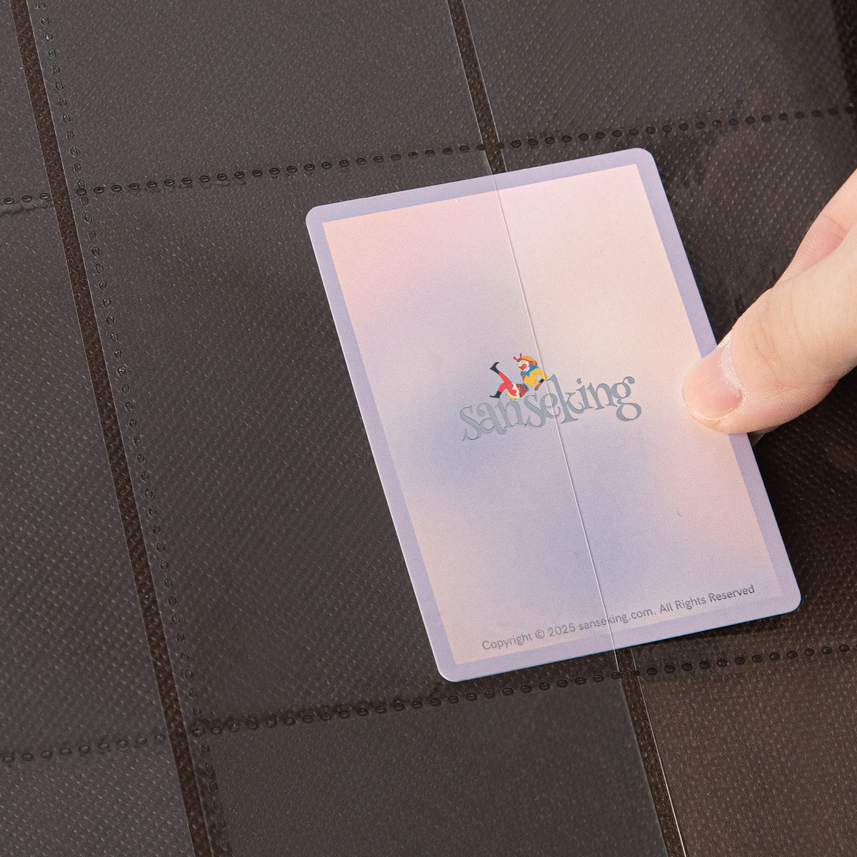 Side-loading pocket holding a sleeved card in the Brown SAKURA binder