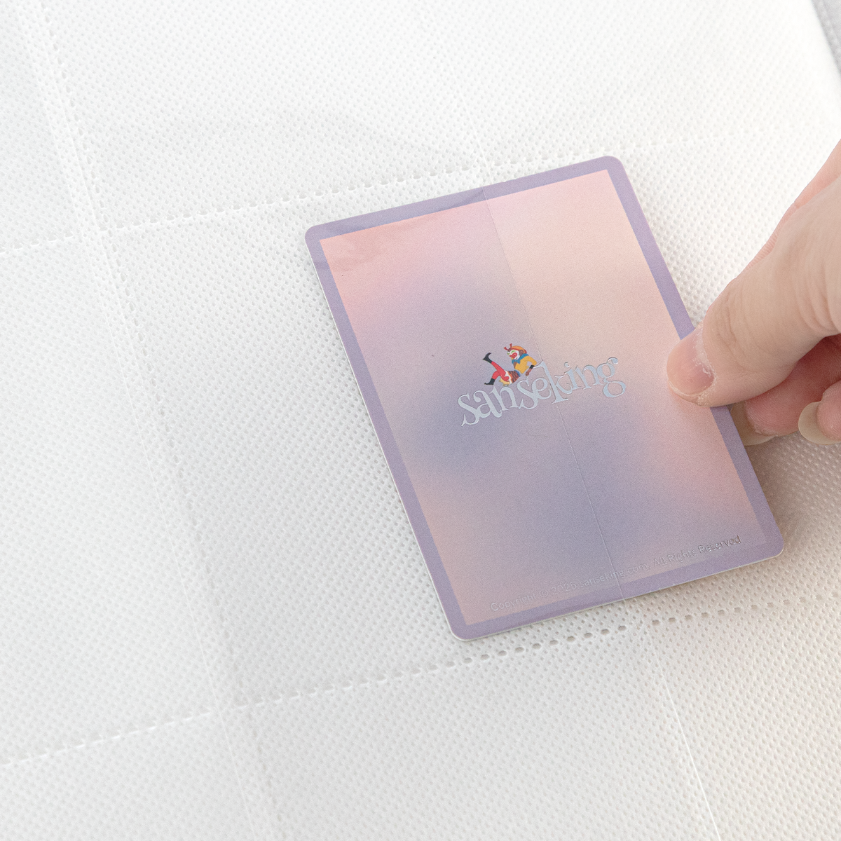 Side-loading pocket holding a sleeved card in the White SAKURA binder