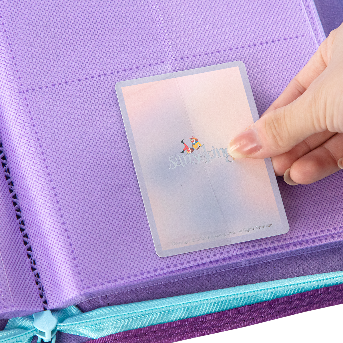Sanseking AXIS-SK Purple 12-pocket trading card binder card being loaded into a pocket