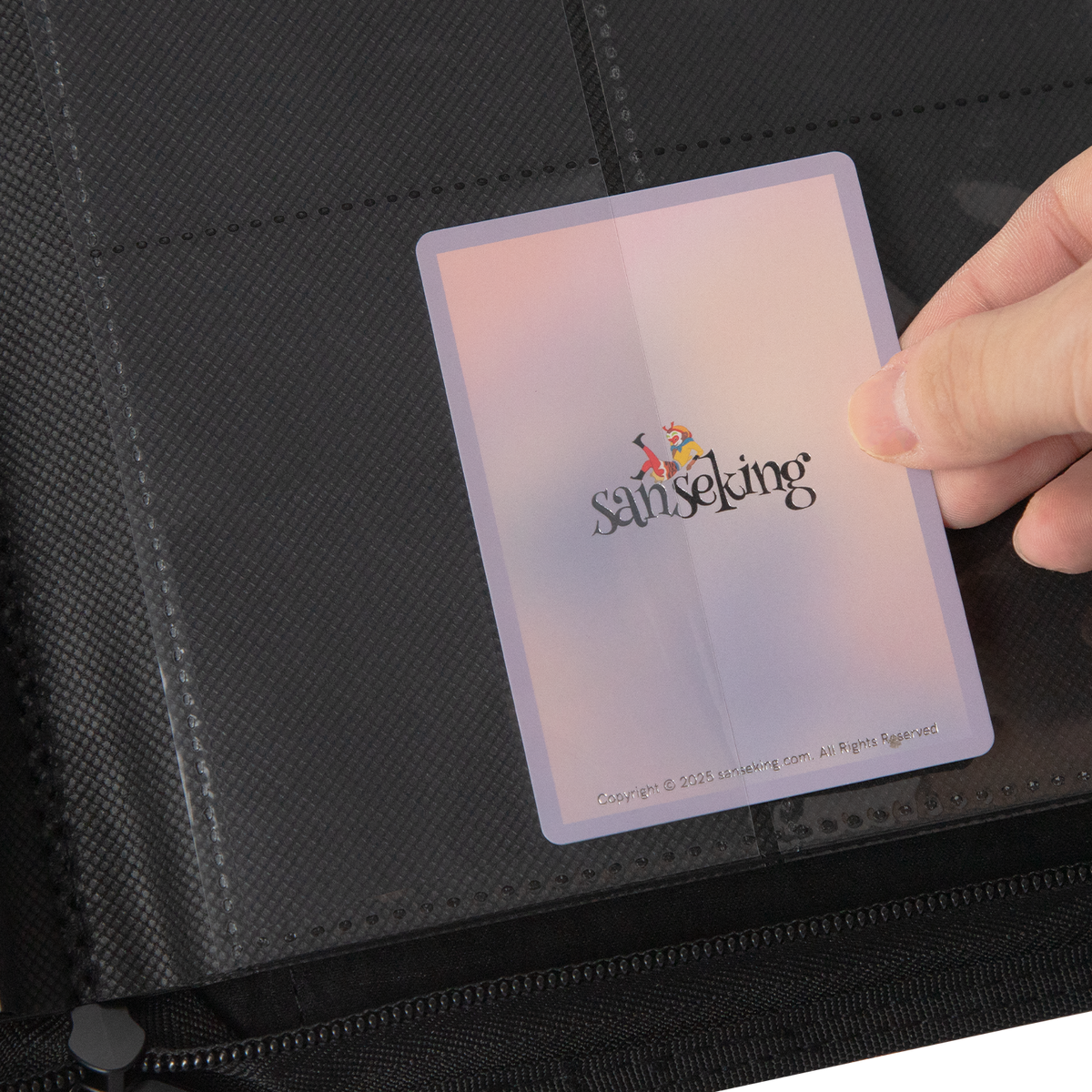 Sleeved trading card sliding into a Hellbringer binder side-loading pocket
